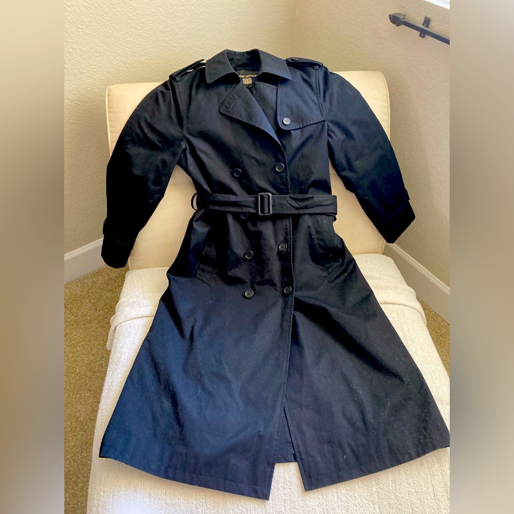 Black women’s trench coat w/belt, zip out liner, extra buttons. Like new.